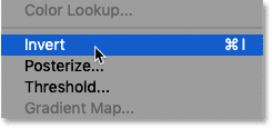 Selecting the Invert image adjustment in Photoshop